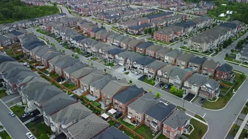 Aerial view of suburban neighborhood, flying upwards and panning down at houses