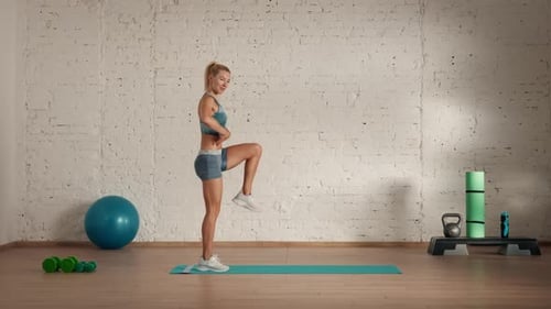 Blonde Woman Performs Mountain Climbers Exercise in Gym