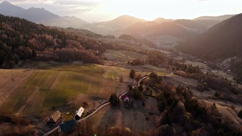Golden Sunset Light Over Carpathian Meadows and Forests in Rural Landscape During Twilight