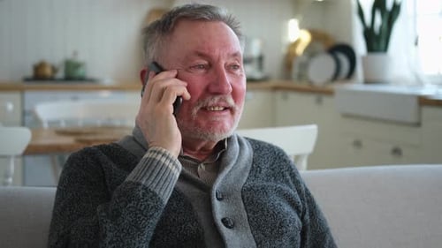 Senior Man Talking on Phone at Home