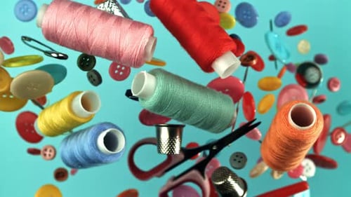 Colorful Sewing Items Floating On Blue Background