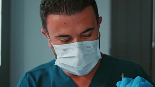 Surgeon Wearing Mask Working in Operating Room