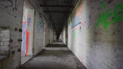 Decaying Hallway with Figure in Abandoned Building
