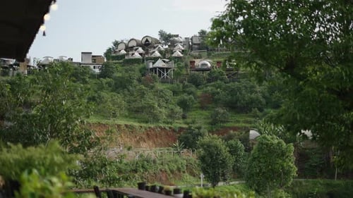 View of a Hill Full of Vegetation and Modern Houses on Top of It in Chiang Mai