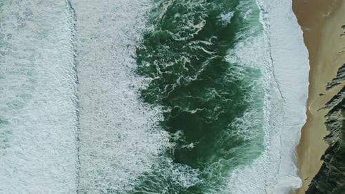 Aerial Top View on Ocean Waves and Sand Beach