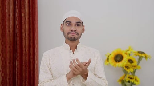 Smiling Young Adult Man Clapping Hands Indoors