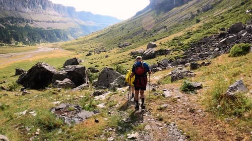 Hikers walking down trail in Ordesa natural park, Spain