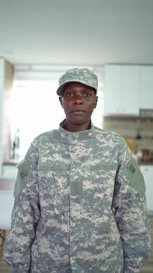 Serious woman in military uniform looking at camera