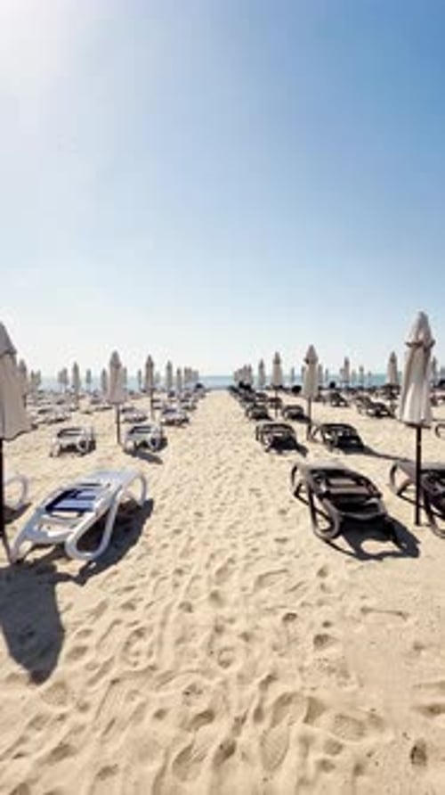 Beautiful View of the Coastline and Sea Walk Through Beach Loungers and Umbrellas on a Coast Empty