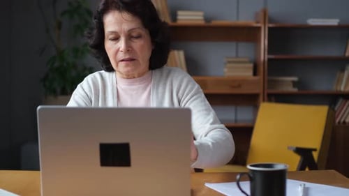 Mature Woman Working at Laptop from Home