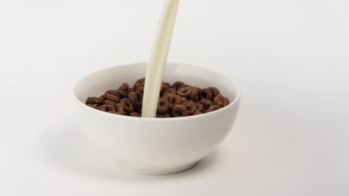 Pouring Milk into Chocolate Cereal Rings