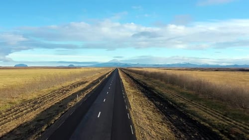 Aerial Flyover Empty Scenic Icelandic road towards Glacier Landscape