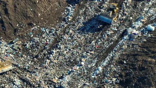 View From Above of Landfill Dump Site for Garbage Waste Managment Bulldozer Tractors Burying Large