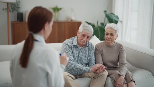 Senior Couple on Appointment with Therapist Young Woman in Modern Clinic