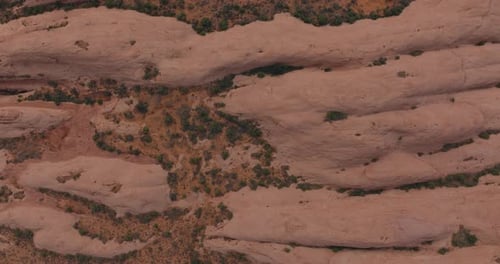 Aerial Shot of Moab's Striking Red Rock Formations Amidst Desert Landscape