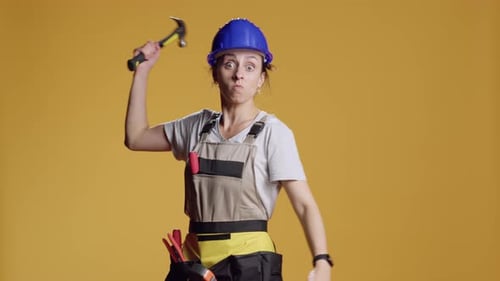 Portrait of Aggressive Constructor Threating with Hammer