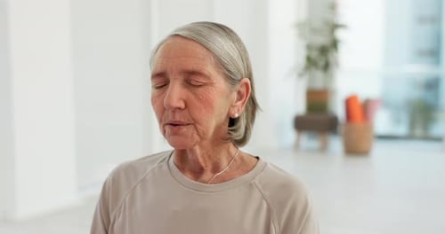 Senior Woman Meditating in Bright Indoor Space