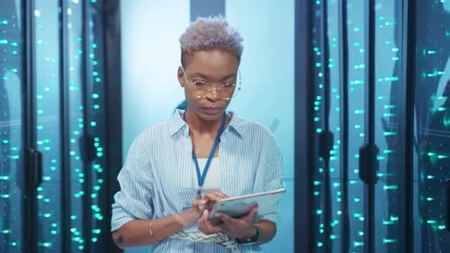 The Modern Data Center Professional is Engaged in Analyzing Complex Data on a Tablet Device