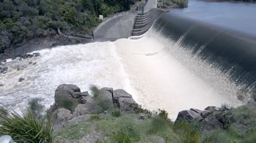 Static shot water flowing on the dam. view of the river channel.