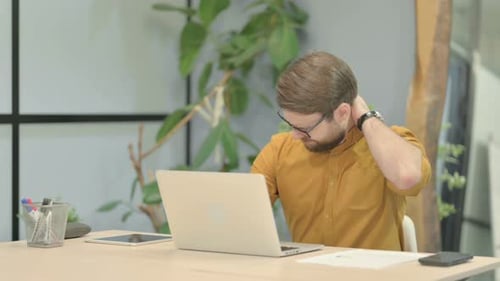 Man Working at Computer with Neck Pain