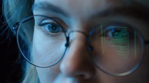 Face with Reflected Computer Code in Glasses