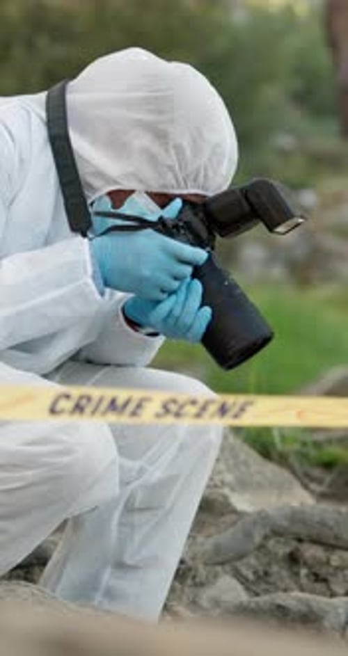 Crime scene, evidence and photographer with camera in woods with hazmat for safety with analysis