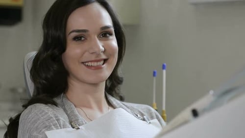 Smiling woman sitting in a dental chair
