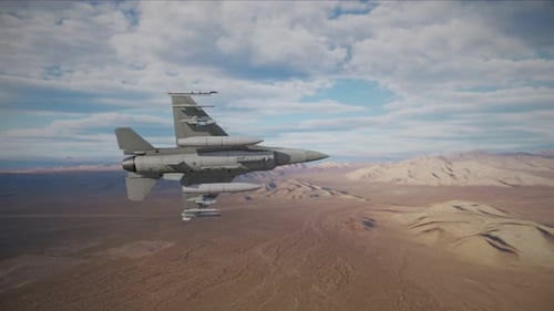 F-16 Falcon fighter jet flying over a desert landscape armed with bombs