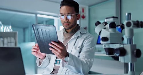 Young Adult Man Using Tablet in Laboratory