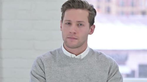 Young Adult Man Stares Directly at Camera