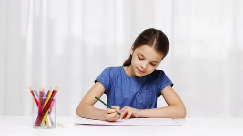 Girl Drawing at Desk with Colored Pencils