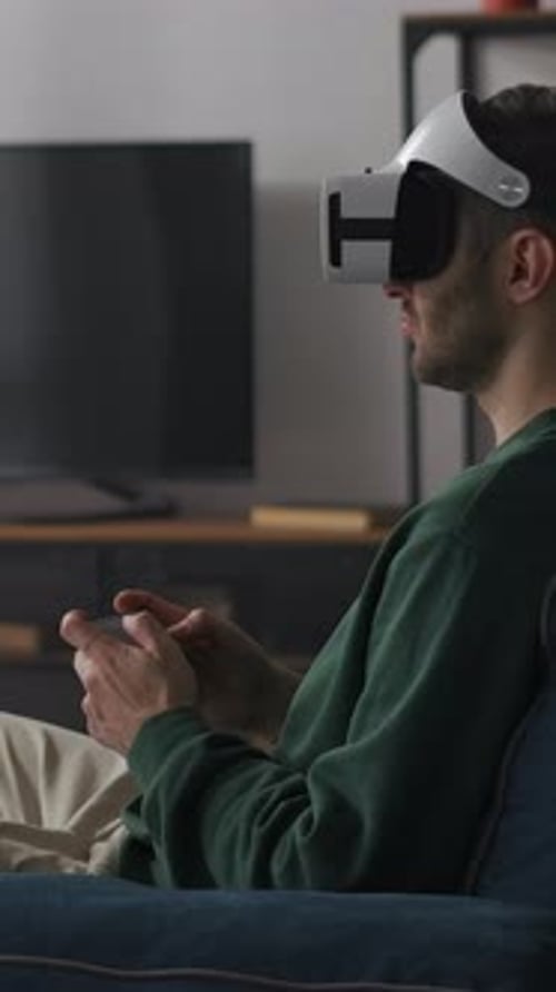 Man Wearing VR Headset Playing Video Game at Home
