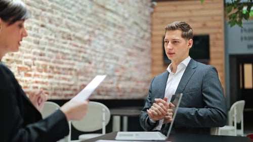 Business Meeting Professionals Negotiate Contract in Modern Office