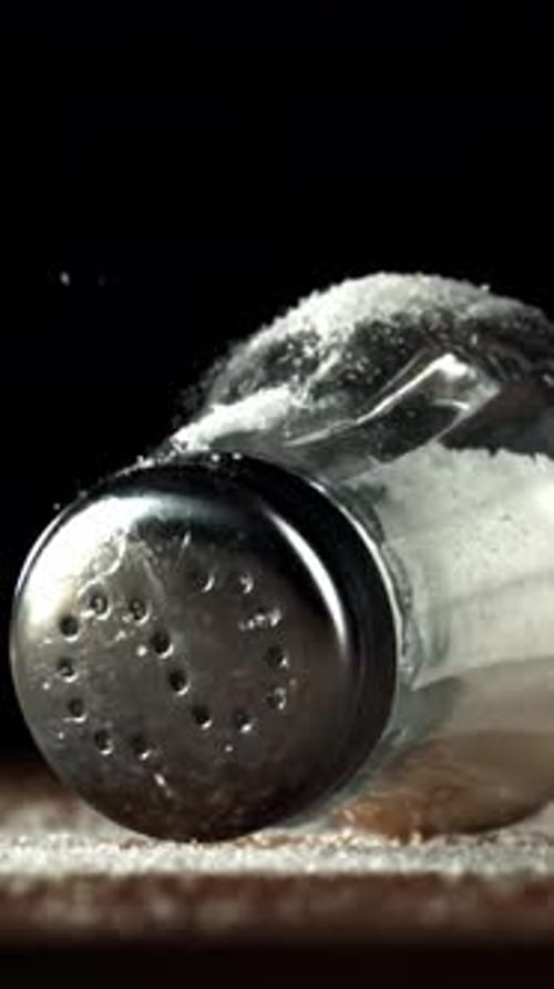 A Salt Shaker Falls on a Wooden Table Filmed on a Highspeed Camera at 1000 Fps