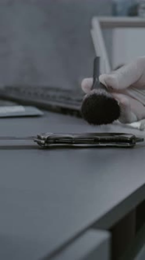 Close Up of Forensic Scientist Finding Fingerprints on Murder Weapon Knife with Brush