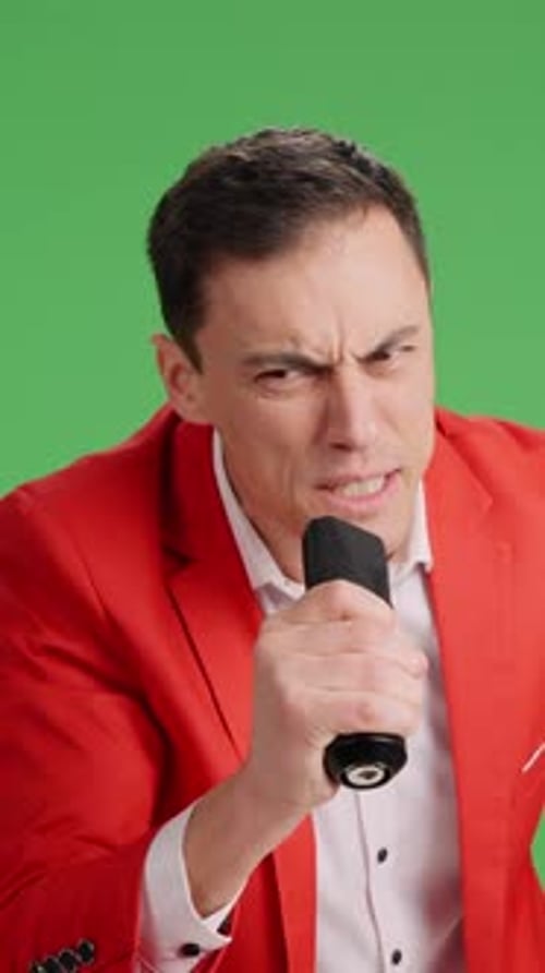 Enthusiastic Showman Introducing Artists with Microphone on Green Screen
