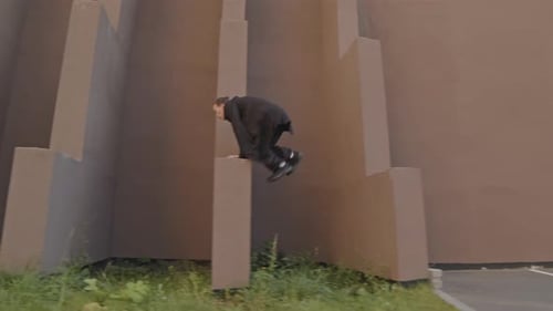 Young Adult Does Parkour in Urban Setting