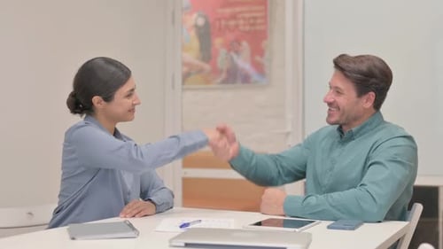 Positive Colleagues Handshake in Modern Workplace