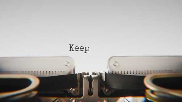 Old mechanical typewriter typing Keep Going Strong in a close-up view ...