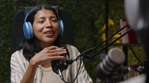 Female Podcast Host Interviewing Guest in Recording Studio