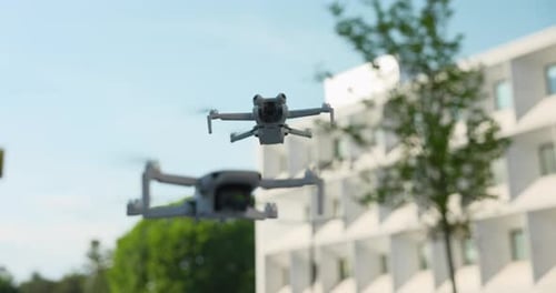 Two Drones Flying in an Urban Environment