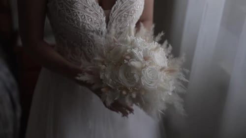 Bride Holding Wedding Bouquet in Natural Indoor Lighting