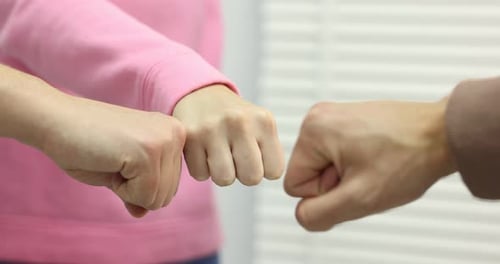 People joining hands together indoors, closeup. Team building