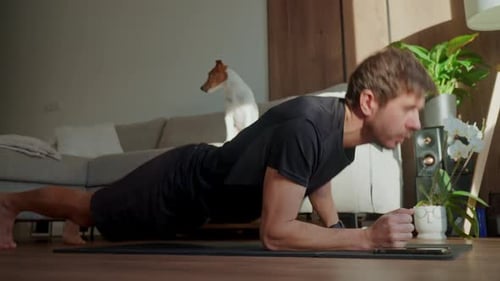 Man Does Plank Exercise at Home with Dog