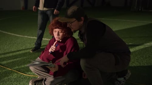 Videographer and Producer Discussing Storyline for American Football Show