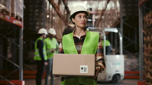 Lady Worker in Warehouse Carrying Package to Storage