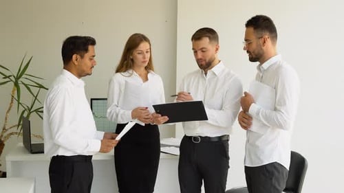 Business Team Discussing Documents in Modern Office