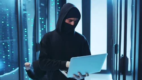 Hooded Figures Hacking Servers in Dark Data Center