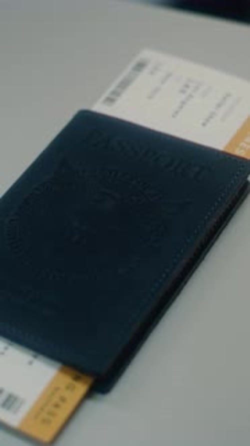 Airport Terminal Close Up of Female Traveler Putting US Passport with Flight Ticket on Counter