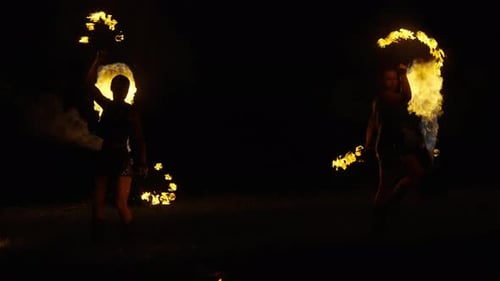 Beautiful Female Jugglers Dancing With Fire Torches And Flamethrower Flashing Fire In Air